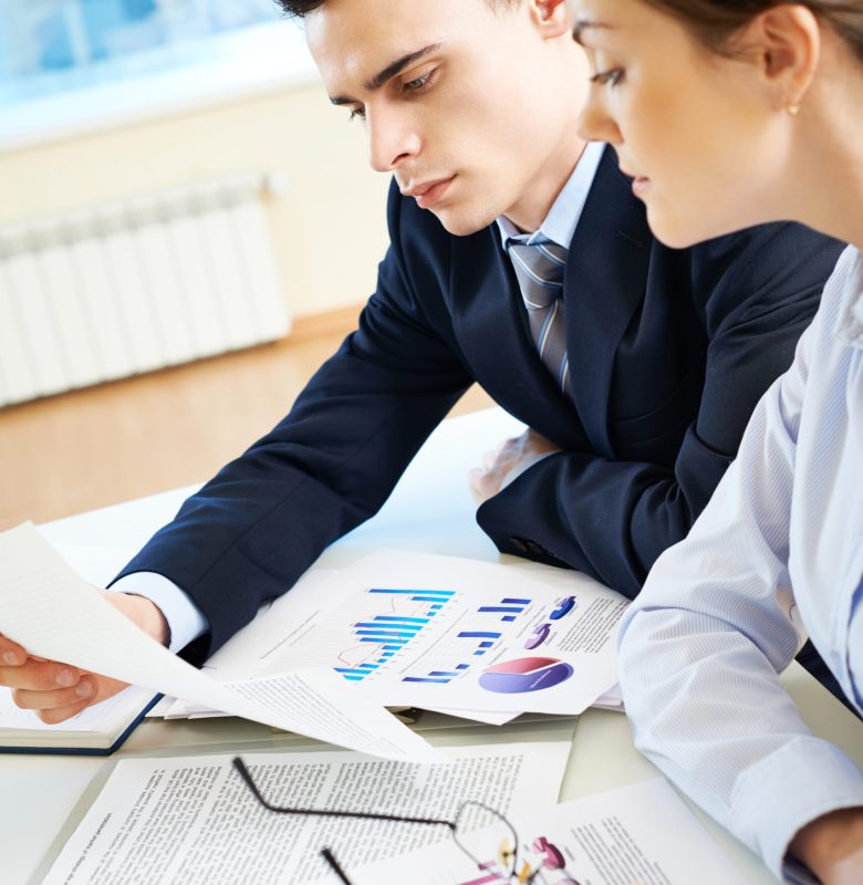 Business partners looking through papers at meeting